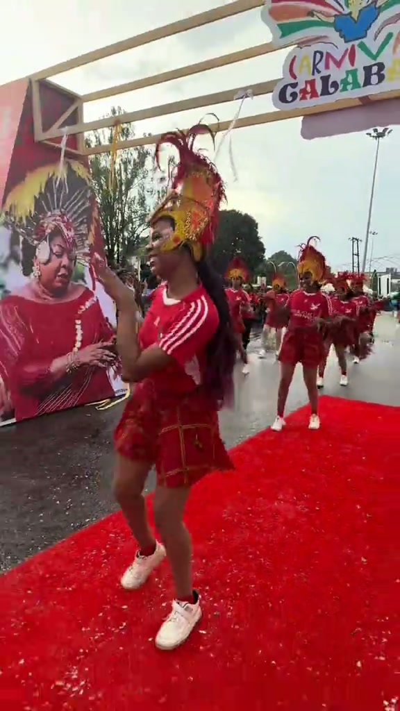 Seagull Band dancer in red costume and feathered headdress at the Carnival dry run in Calabar