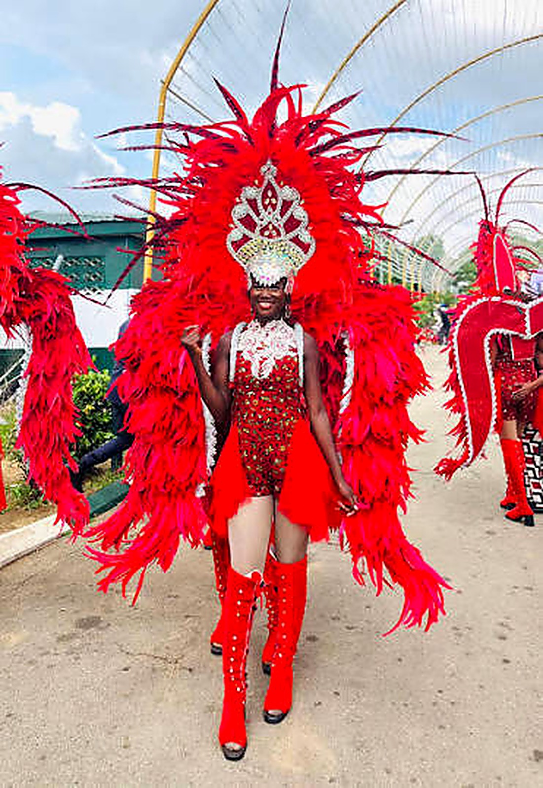 Dancer in full red plume headdress and boots