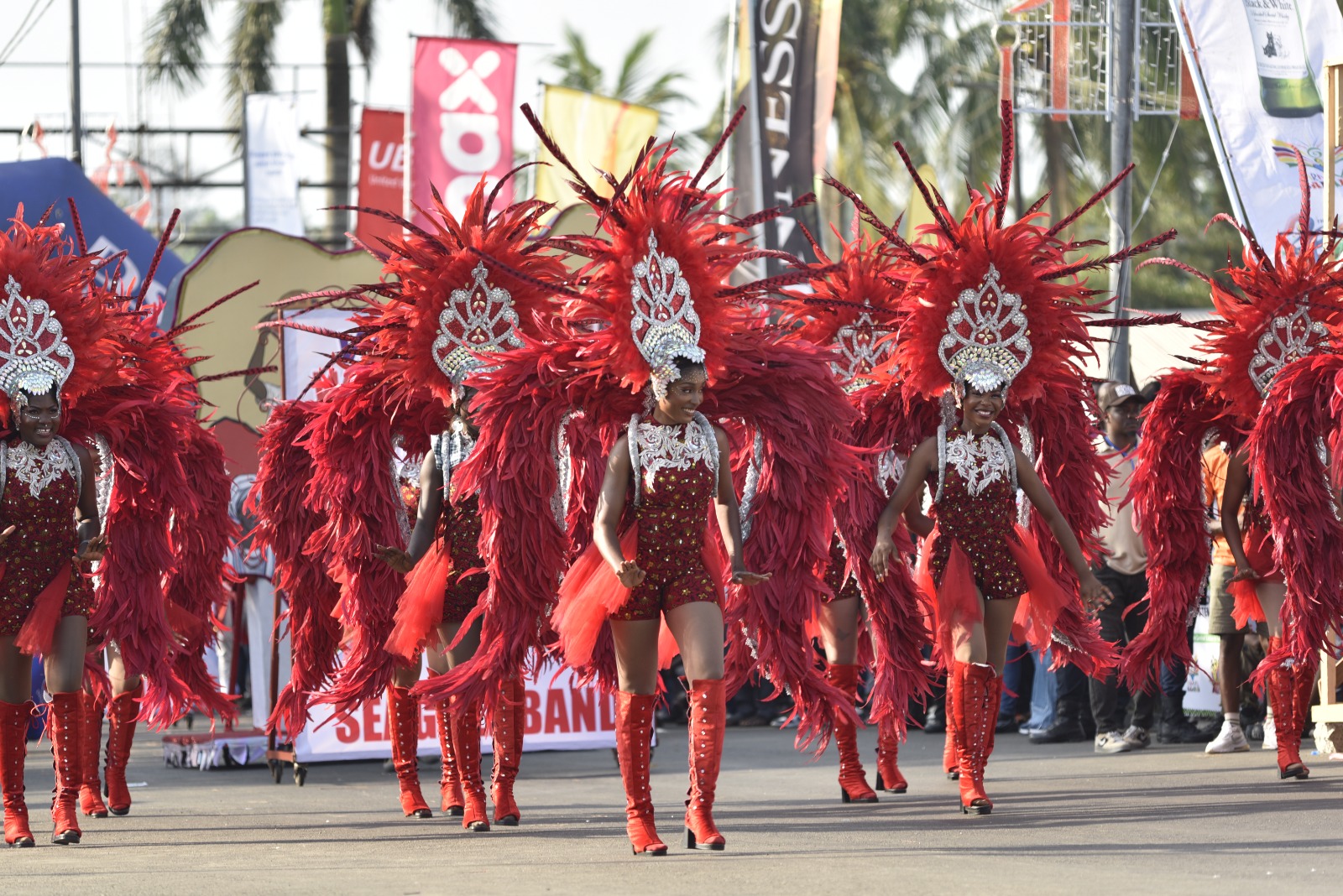 Seagull Band performer in crimson plumes on the parade route